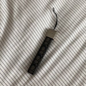 Used coach phone charm